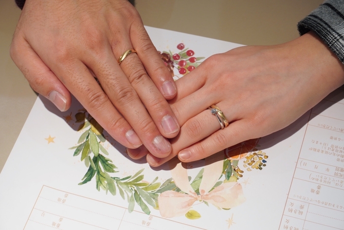 婚姻届と結婚指輪を着けている手元