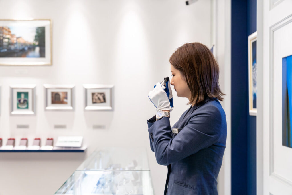 スタッフがルーペでダイヤモンドを見ている